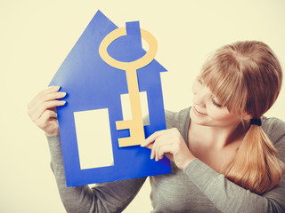 Young lady holding housing symbols.