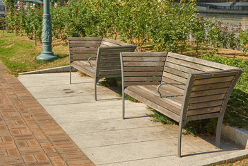 Wooden benches in the garden. Close up picture of two wooden benches in sunny day.