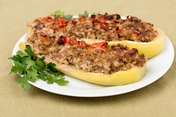 Stuffed zucchini with a mixture of vegetables with cheese and herbs. Traditionally baked squash filled with minced meat, cooked rice, onions, spices, covered with red paprika and cheese.Closeup