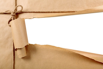 Torn paper package parcel brown background tied with string or rope white strip opening ripped...