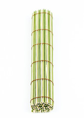Traditional green bamboo pad texture, rolled. Old Bamboo pad texture on white background. Bamboo weave pattern. Mat for food serving. Closeup.