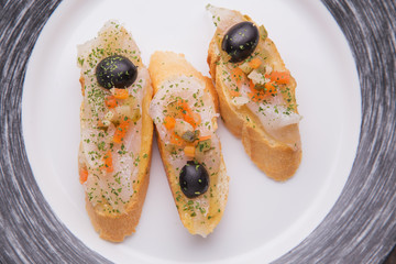Salmon sandwiches, served as tapas in a bar, shot on a wooden ta
