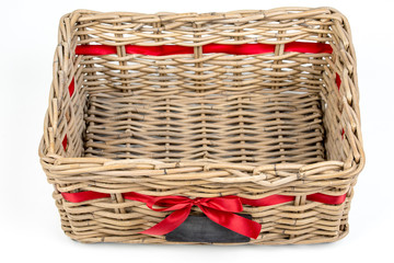 Woven rectangle box,basket with red satin ribbon (tape),small blackboard. Vintage Christmas decoration box for Christmas and new year, isolated on the white background. Empty basket. Top, side view