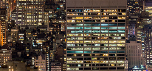 Office windows illuminated at night