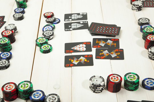 Combination of cards, the game  poker on a white wooden table
