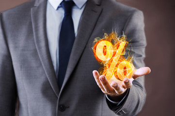 Businessman with percent sign in high interest concept