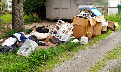 Trash and litter in residential neighborhood alley. Horizontal.
