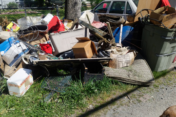 Trash and litter in residential neighborhood alley. Horizontal.