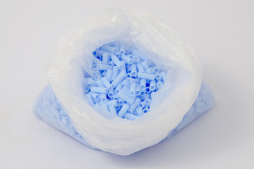 Blue plastic bead in bag
