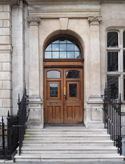 wooden double doors of stone building