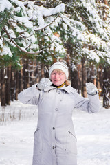 Happy mature woman dancing in winter park