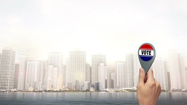 Hand Holding A Vote Badge - City Scene