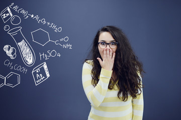 Young amazed woman on blue gray background with biology graphs.