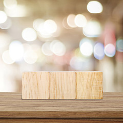 Three wooden cubes on table over blur bokeh background