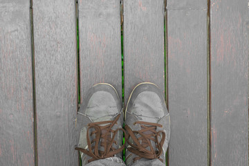 Fototapeta na wymiar Feet concept with old brown shoes with space for text or symbol