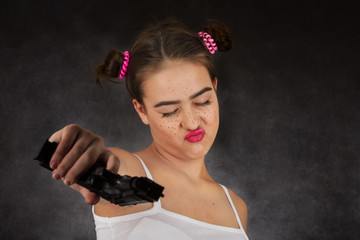fun teenager girl with gun on black background