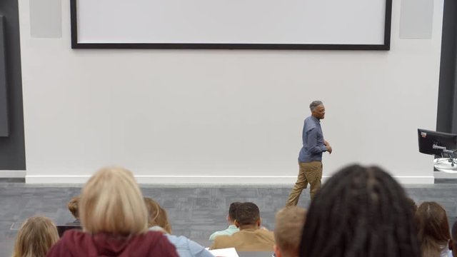 University lecture in lecture theatre, back row student POV