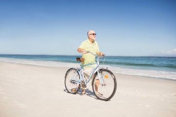 Fototapeta premium Smiling senior man with bike
