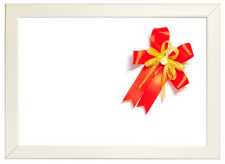 Shiny red ribbon bow decorated on white photo frame, season gree