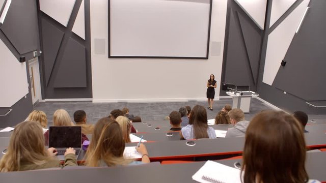 University lecture in lecture theatre, back row student POV