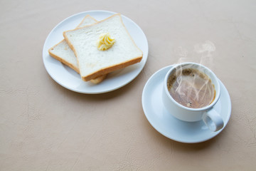 Coffee and toast and butter with copy space