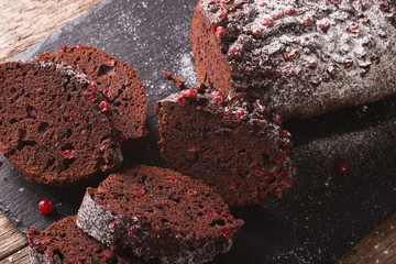 Delicious sliced chocolate cake with cranberry closeup. horizontal