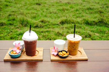 iced coffee and biscuit alphabet with rice field background