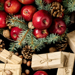 Fototapeta na wymiar Christmas and New year. Apples with pine cones, nuts in basket with fir branches.