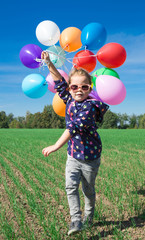Little girl playing with balloons