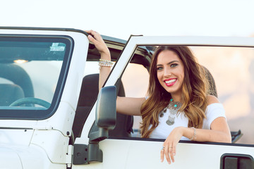 Young Smiling Beautiful Woman Sitting With Car On Road Trip. Selective Focus.