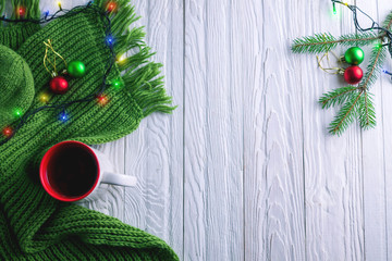 Cup of tea with a scarf on Christmas background