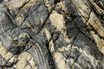 Black stone with a gray pattern. Sinuous lines