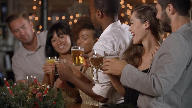 Friends celebrating together at a Christmas party in a bar