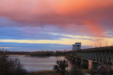 Fototapeta na wymiar Bridge across river Dnieper at sunset in Kremenchug, Ukraine 