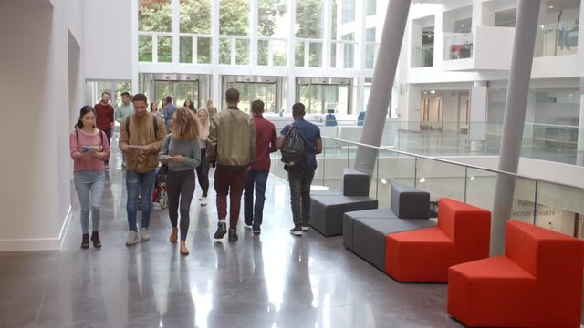 Students walk through the foyer of a modern university