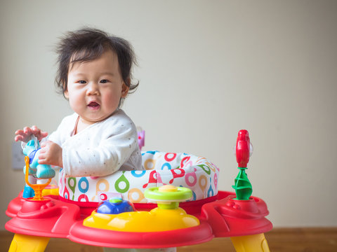 Asian baby girl playing entertainer toy