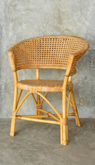wicker/rattan chair on cement wall background