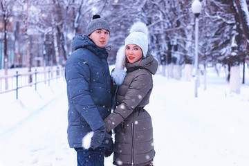 Fototapeta na wymiar young couple of lovers walk in winter park