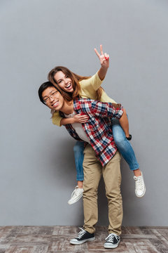 Full length portrait of a young cheerful couple having fun
