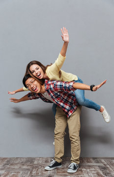 Portrait of a young multiracial couple enjoying piggyback ride