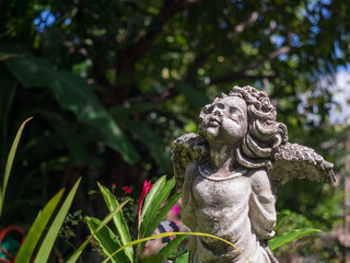 Closeup vintage beautiful charm cement angle statue in the garde