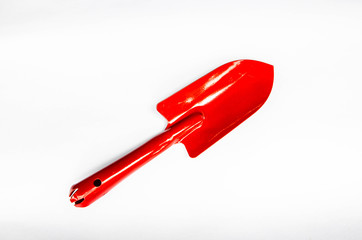 Garden trowel, red color on white background