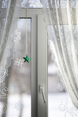 window with curtains and christmas star
