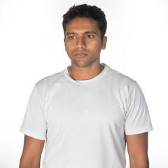 A fit young man looking thoughtfully off camera in studio shot