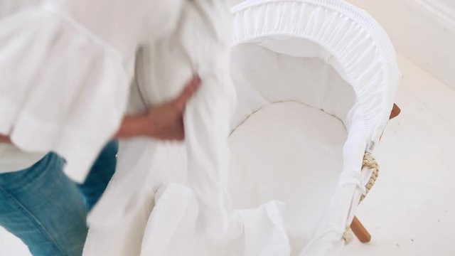 Mother placing baby in bassinet