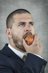 businessman eating an apple
