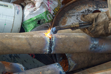 A worker uses a oxygen acetylene cutting