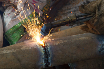 A worker uses a oxygen acetylene cutting