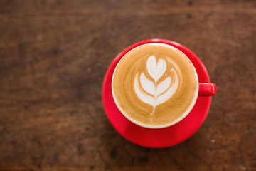 Coffee cup top view on old wooden table background.