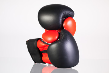 Red and black boxing gloves on a glass table